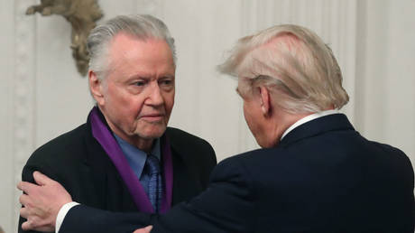 Donald Trump (R) presents actor Jon Voight with the National Medal of Arts during a ceremony at the White House in Washington DC, November 21, 2019